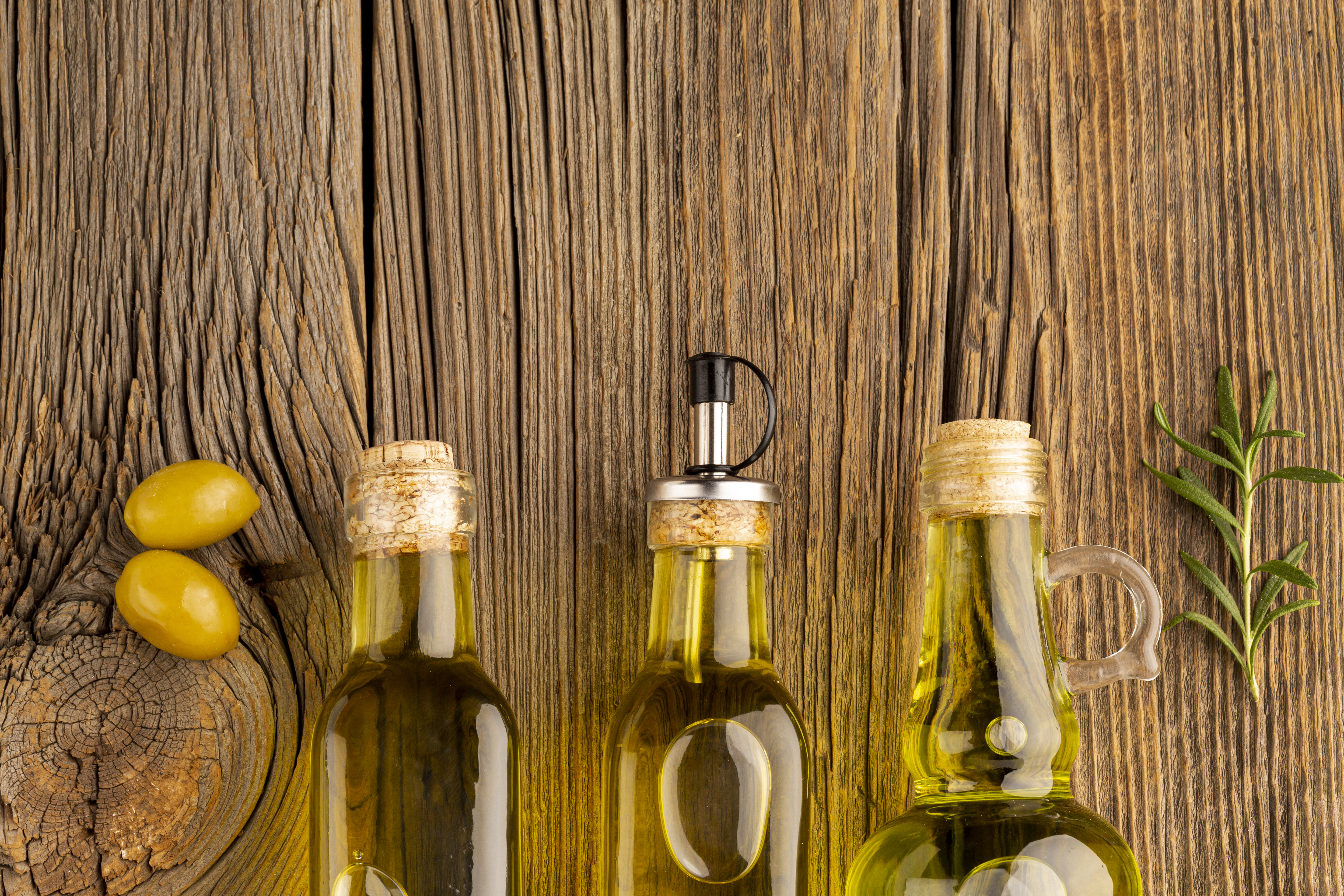 yellow-olives-oil-bottles-wooden-background
